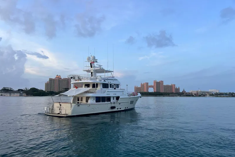 The Image of Nordhavn N78 yacht from 2009 on calm waters with cityscape background. - 0