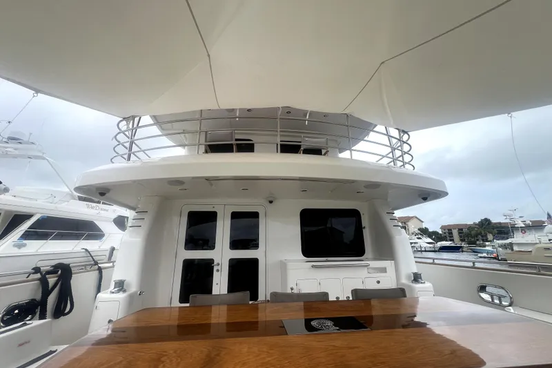Slide: The Image of Luxurious 2009 Nordhavn N78 yacht deck with elegant wooden table and marina view. - 14