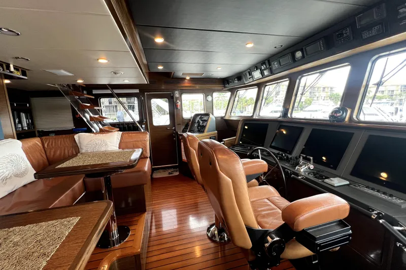 Slide: The Image of Luxurious 2009 Nordhavn N78 yacht interior with leather seating and advanced navigation controls. - 23