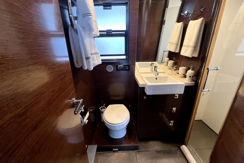 Slide: The Image of Luxurious bathroom in 2009 Nordhavn N78 yacht with modern fixtures and elegant wood paneling. - 26