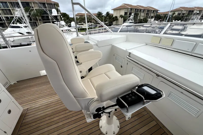 Slide: The Image of Luxurious helm seating on 2009 Nordhavn N78 yacht, featuring sleek design and modern controls. - 27