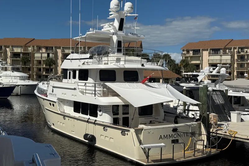 Slide: The Image of Nordhavn N78 yacht docked at marina, 2009 model, with buildings in background. - 3