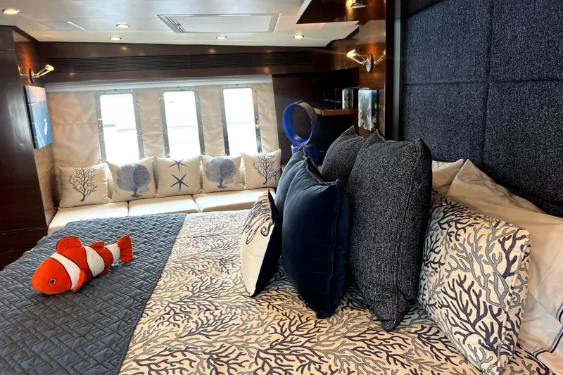 Slide: The Image of Luxurious Nordhavn N78 2009 yacht bedroom with nautical-themed decor and plush bedding. - 30