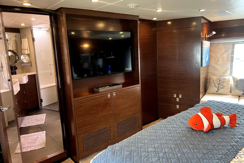 Slide: The Image of Luxurious Nordhavn N78 yacht bedroom with TV, ensuite bathroom, and plush decor. - 31