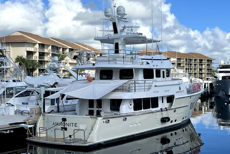Slide: The Image of Luxury Nordhavn N78 yacht docked at marina, 2009 model, clear sky background. - 5