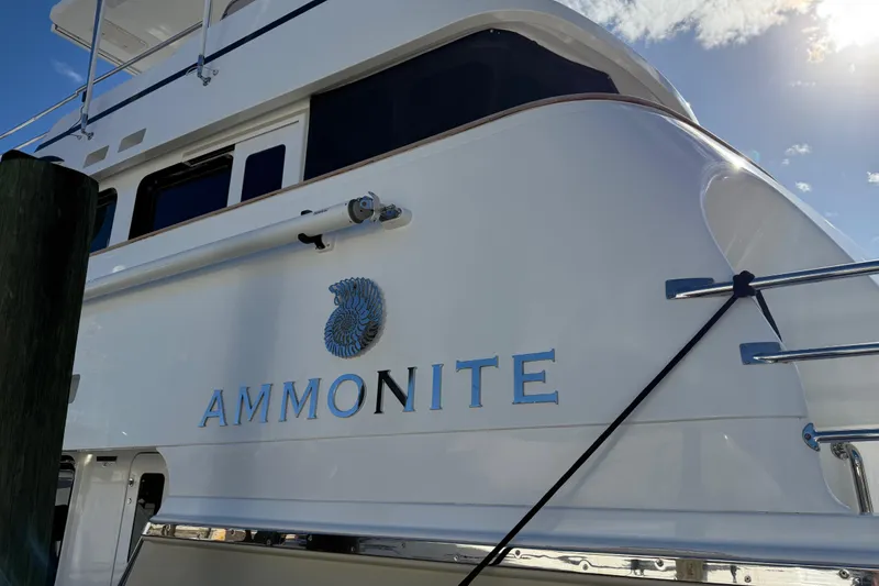 Slide: The Image of Nordhavn N78 yacht "Ammonite" docked, showcasing sleek design and elegant lettering. - 50