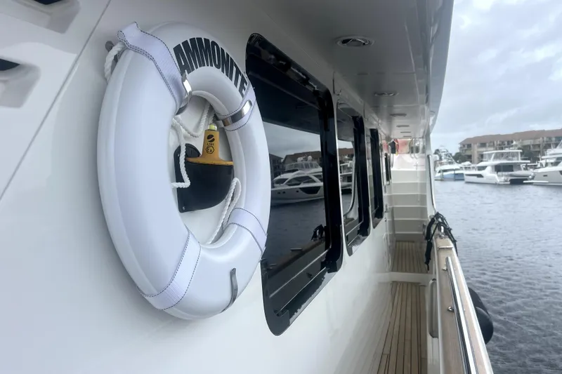 Slide: The Image of Nordhavn N78 yacht deck with life ring, docked in marina, 2009 model. - 6