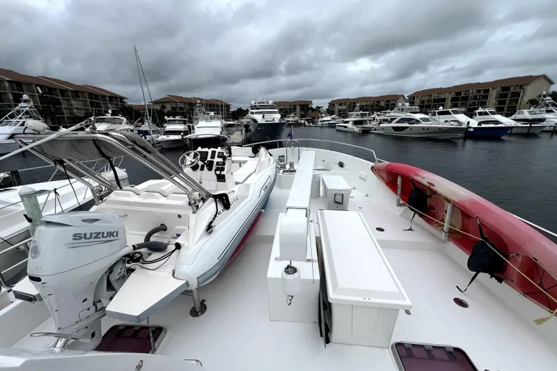 Slide: The Image of Deck view of 2009 Nordhavn N78 yacht with Suzuki motor, docked in marina. - 8