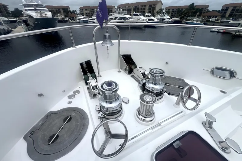 Slide: The Image of Deck of 2009 Nordhavn N78 yacht with winches and anchor equipment in marina setting. - 9