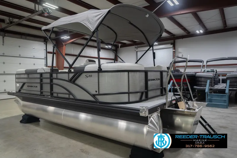 Slide: The Image of 2026 Bennington 20 SSR pontoon boat in indoor showroom with canopy. - 10