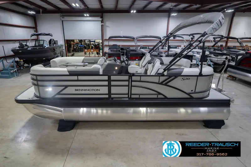 The Image of 2026 Bennington 20 SSR pontoon boat in showroom, featuring sleek design and modern amenities. - 2