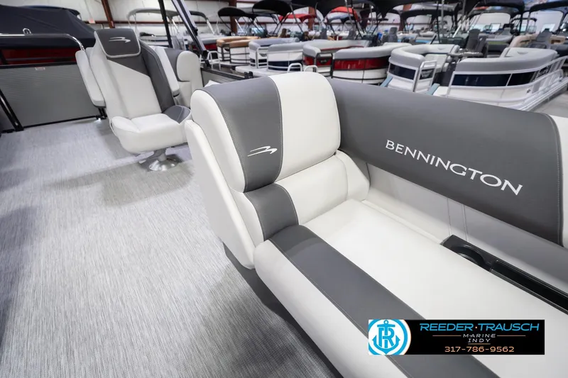 Slide: The Image of 2026 Bennington 20 SSR boat interior with gray and white seating in showroom. - 24