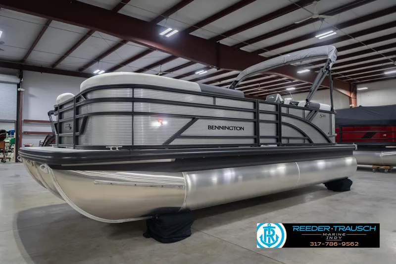 Slide: The Image of 2026 Bennington 20 SSR pontoon boat in a showroom, side view. - 3