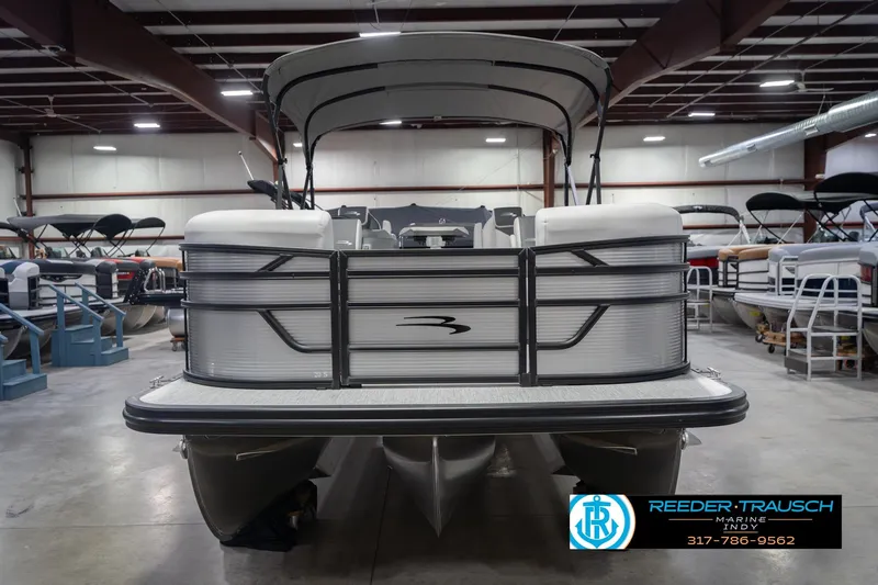 Slide: The Image of 2026 Bennington 20 SSR pontoon boat in showroom, front view with canopy. - 5