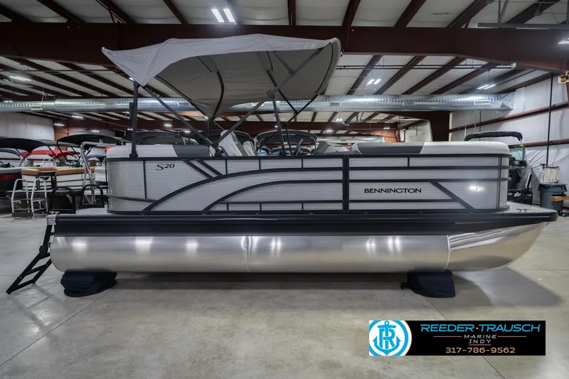 Slide: The Image of 2026 Bennington 20 SSR pontoon boat in a showroom with canopy and sleek design. - 7