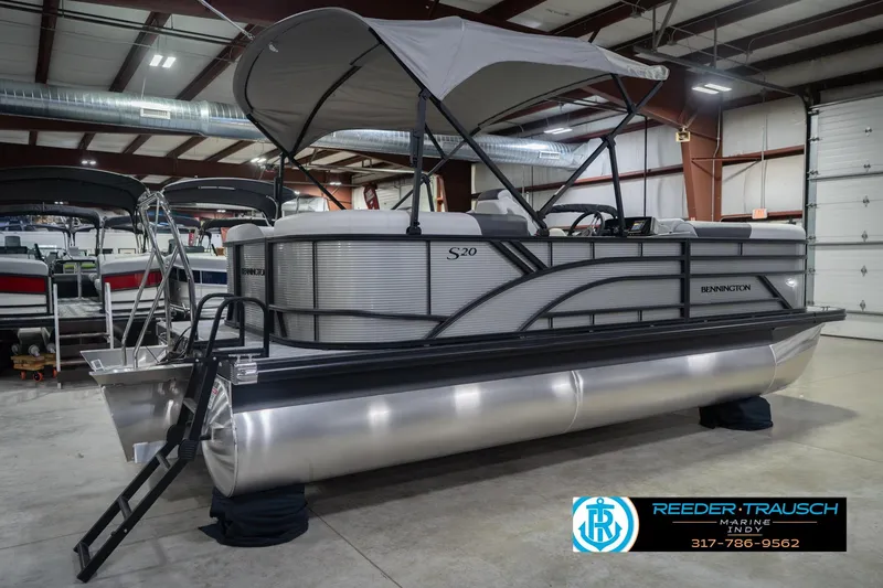 Slide: The Image of 2026 Bennington 20 SSR pontoon boat in showroom with canopy and sleek design. - 8