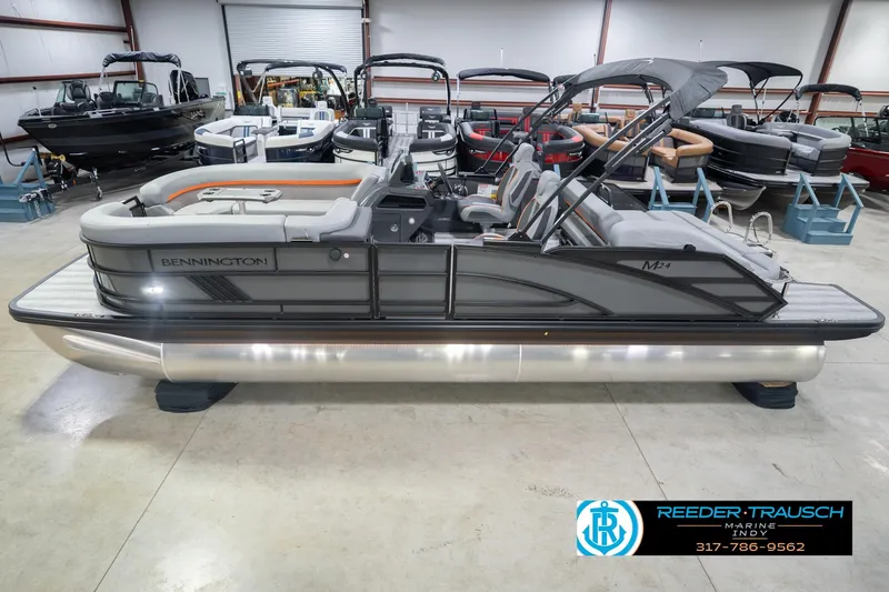 The Image of 2026 Bennington 24 MSB pontoon boat in showroom, side view with sleek design. - 0