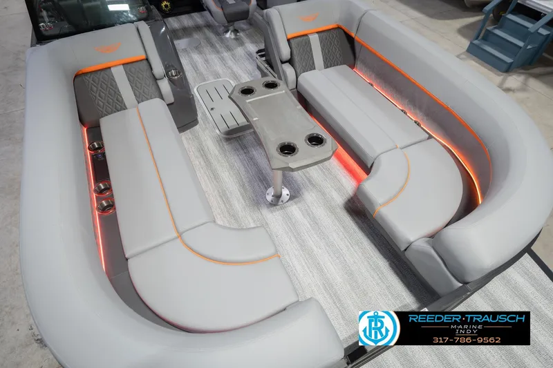 Slide: The Image of 2026 Bennington 24 MSB pontoon boat interior with gray seating and orange accents. - 13