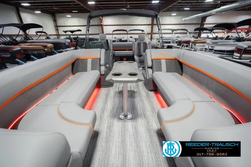 Slide: The Image of 2026 Bennington 24 MSB pontoon boat interior with modern seating and ambient lighting. - 16