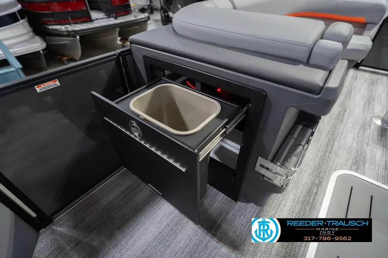 Slide: The Image of Interior of 2026 Bennington 24 MSB boat with open storage compartment. - 27