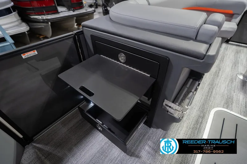 Slide: The Image of 2026 Bennington 24 MSB boat interior with open storage compartment and seating. - 28