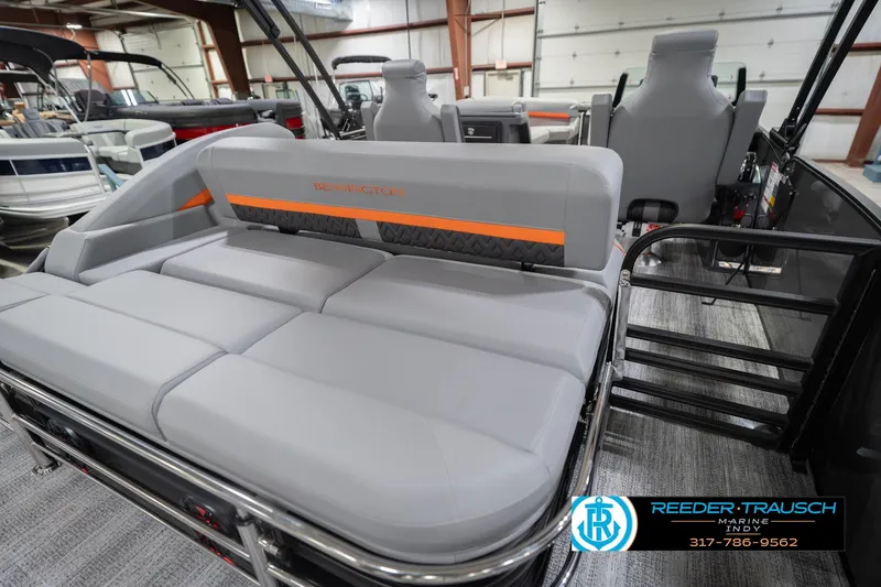 Slide: The Image of 2026 Bennington 24 MSB pontoon boat interior with gray seating and orange accents. - 31