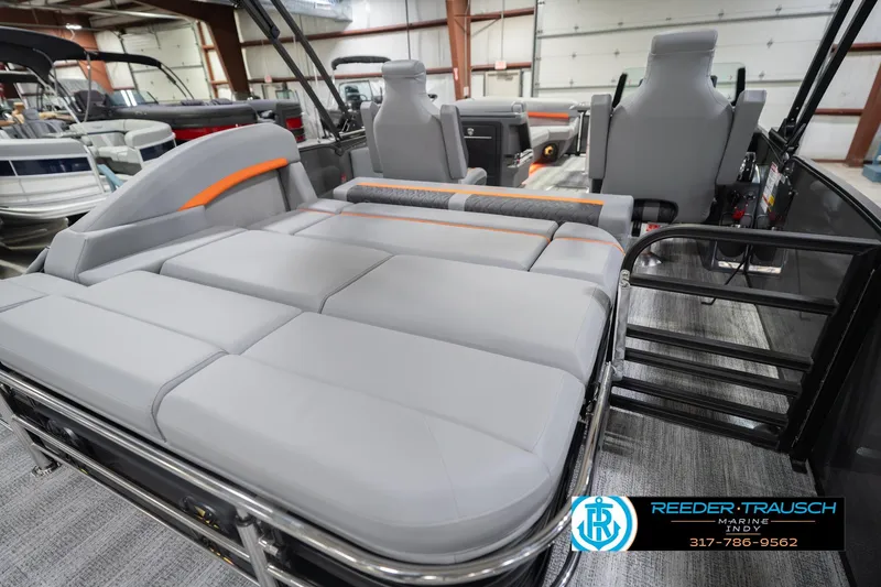 Slide: The Image of 2026 Bennington 24 MSB pontoon boat interior with gray seating and orange accents. - 32