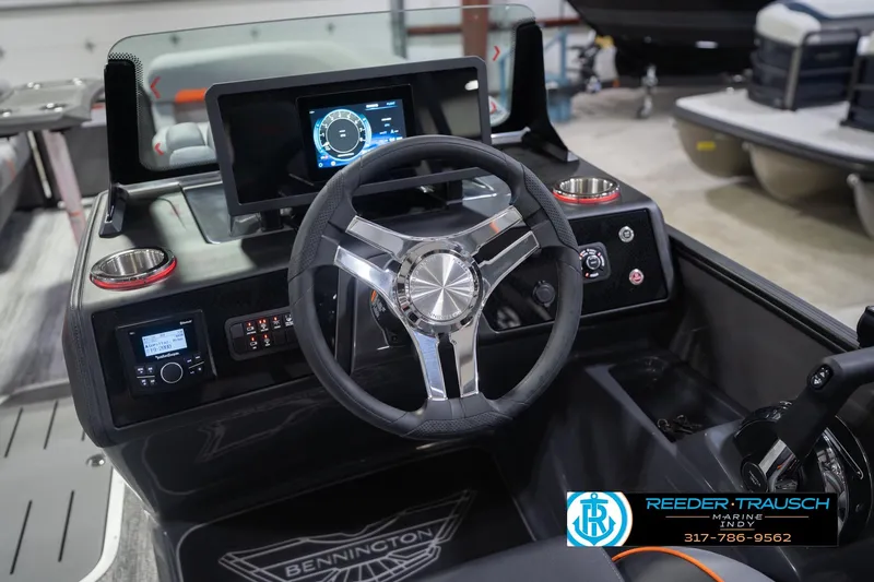 Slide: The Image of 2026 Bennington 24 MSB boat dashboard with steering wheel and digital display. - 37