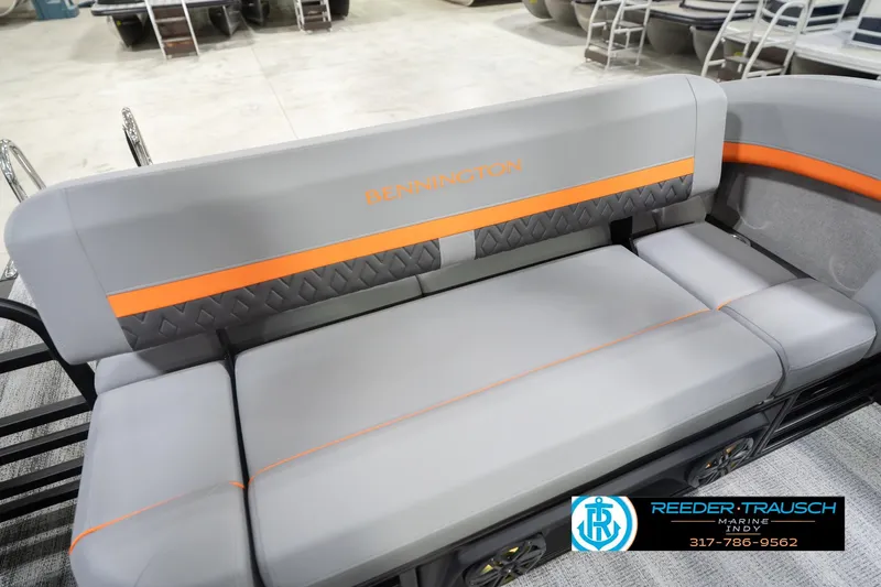 Slide: The Image of 2026 Bennington 24 MSB boat seating with gray and orange accents in showroom. - 46