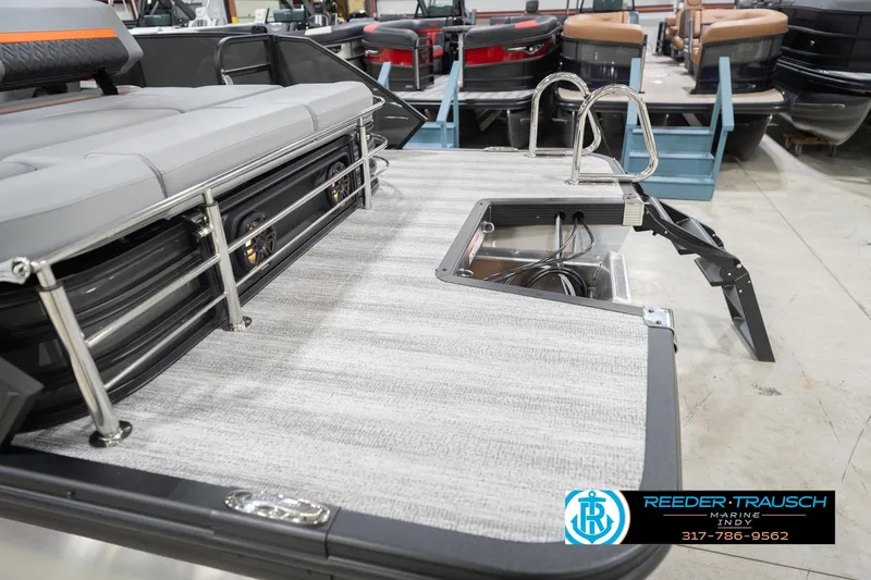 Slide: The Image of 2026 Bennington 24 MSB boat interior with seating and storage, displayed at Reeder-Trausch Marine. - 56