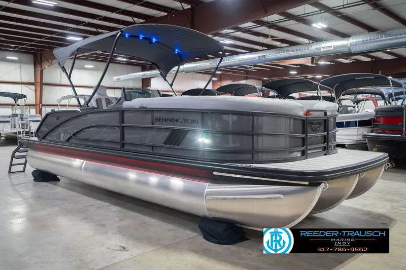 Slide: The Image of 2026 Bennington 24 MSB pontoon boat displayed in indoor showroom. - 6