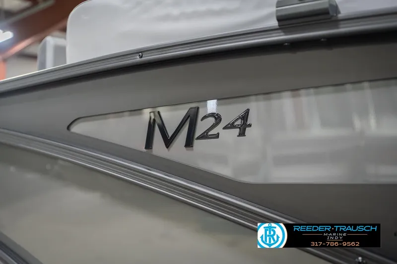 Slide: The Image of 2026 Bennington 24 MSB boat with M24 logo, Reeder Trausch Marine branding. - 61