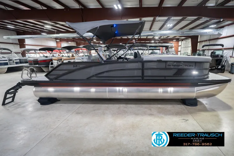 Slide: The Image of 2026 Bennington 24 MSB pontoon boat in showroom, side view. - 7