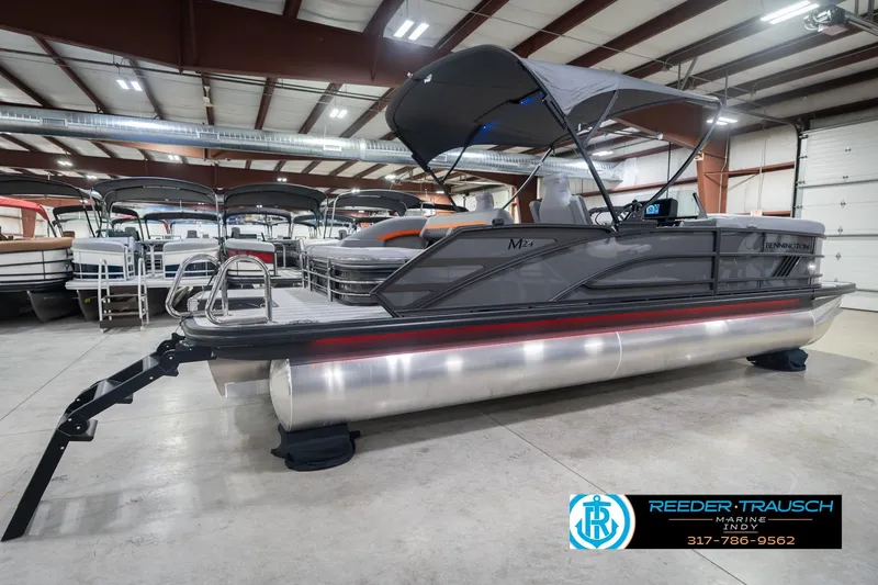 Slide: The Image of 2026 Bennington 24 MSB pontoon boat in showroom, featuring sleek design and canopy. - 8