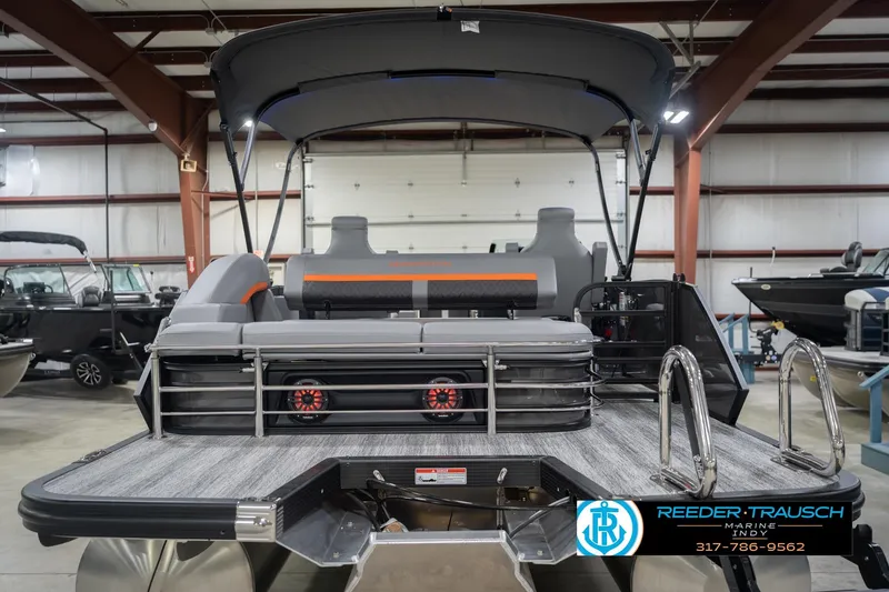 Slide: The Image of 2026 Bennington 24 MSB pontoon boat in showroom with sleek design and modern features. - 9