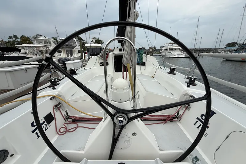 Slide: The Image of 2022 J Boats J/112E sailboat cockpit with steering wheel, docked in marina. - 10
