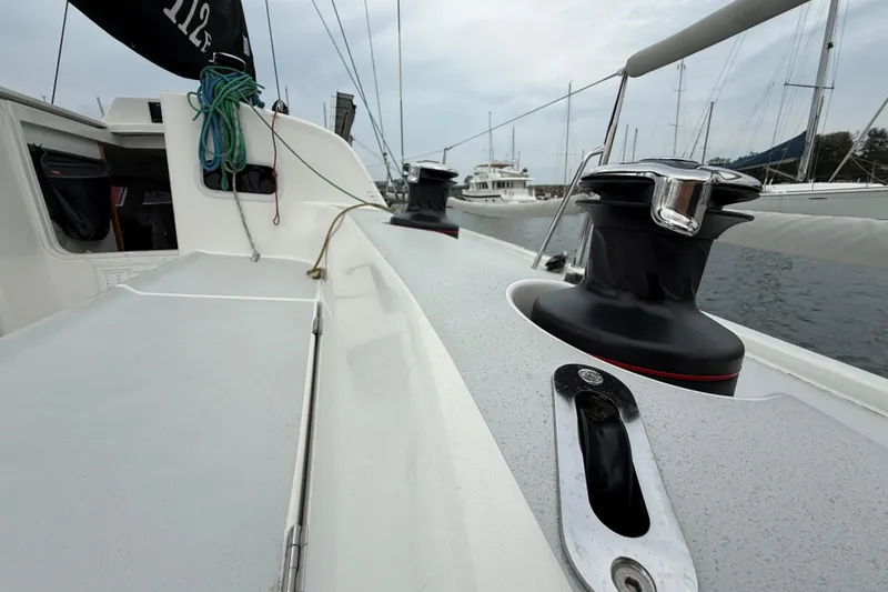 Slide: The Image of 2022 J Boats J/112E sailboat deck with winches and ropes in marina. - 14