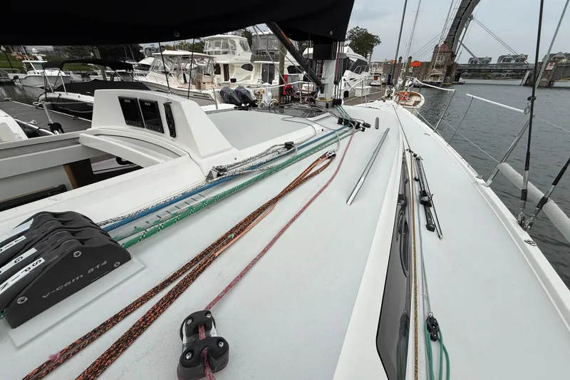Slide: The Image of 2022 J Boats J/112E sailboat deck with rigging and marina view. - 16