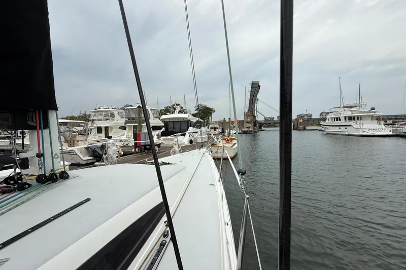 Slide: The Image of 2022 J Boats J/112E docked in a marina with a drawbridge in the background. - 19