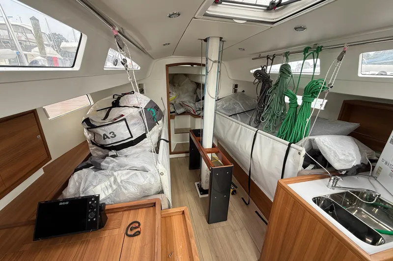 Slide: The Image of Interior of 2022 J Boats J/112E sailboat with ropes, sails, and wooden cabinetry. - 27