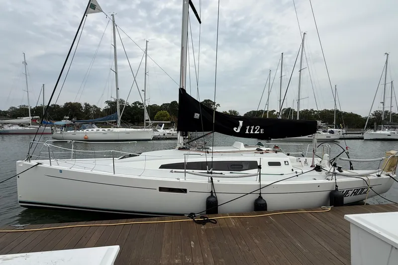 Slide: The Image of 2022 J Boats J/112E sailboat docked at a marina with other yachts. - 3