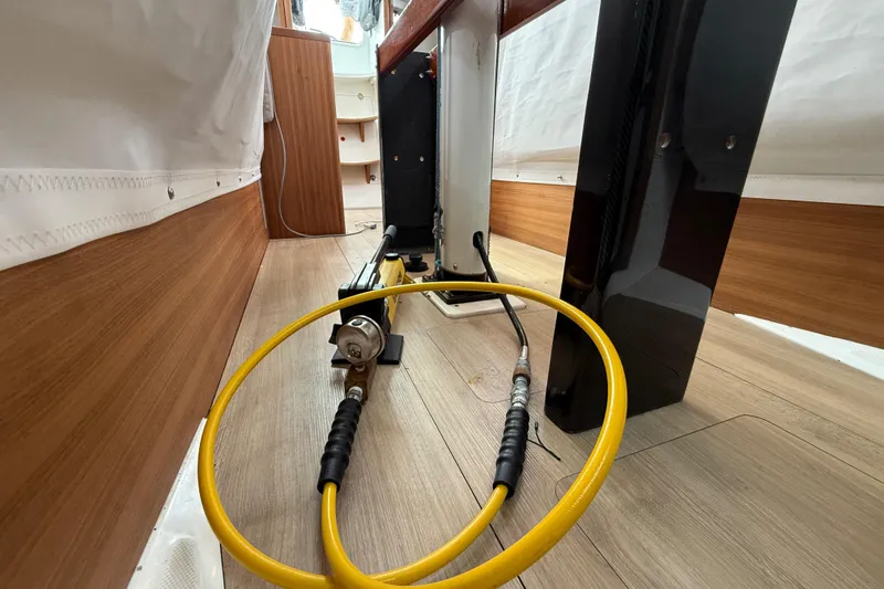 Slide: The Image of Interior view of 2022 J Boats J/112E sailboat, featuring cables and wooden flooring. - 30