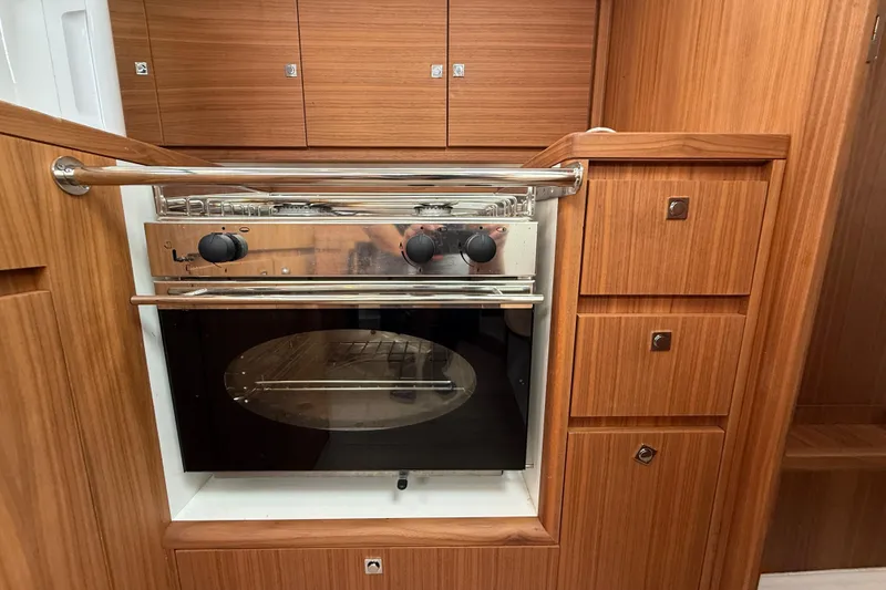 Slide: The Image of Modern kitchen in 2022 J Boats J/112E yacht with wooden cabinetry and stainless steel oven. - 32