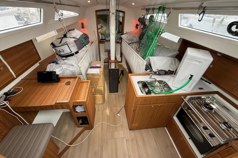 Slide: The Image of Interior of 2022 J Boats J/112E sailboat with modern wood finish and compact kitchen. - 33