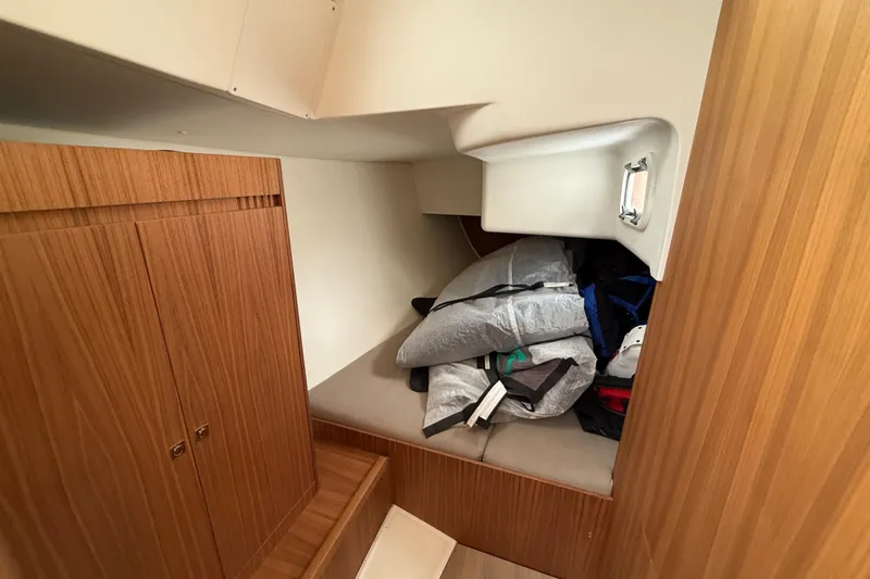 Slide: The Image of 2022 J Boats J/112E cabin interior with wooden cabinetry and storage area. - 35