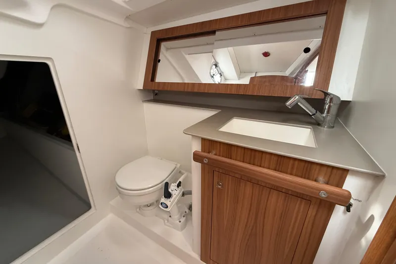 Slide: The Image of 2022 J Boats J/112E yacht bathroom with wooden cabinetry, sink, and toilet. - 36