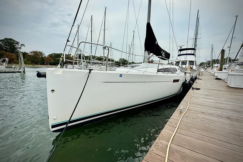 Slide: The Image of 2022 J Boats J/112E sailboat docked at marina, showcasing sleek design and modern features. - 5