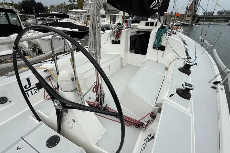 Slide: The Image of 2022 J Boats J/112E sailboat cockpit with steering wheel and winches in marina. - 9