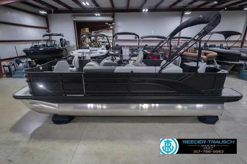 The Image of 2026 Bennington 21 SF pontoon boat displayed indoors at Reeder-Trausch Marine showroom. - 0