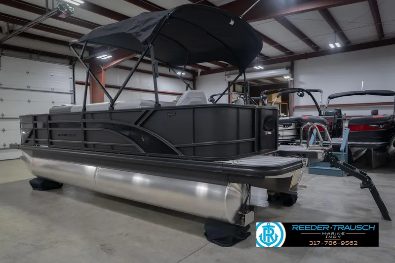 Slide: The Image of 2026 Bennington 21 SF pontoon boat in showroom with canopy and sleek design. - 10